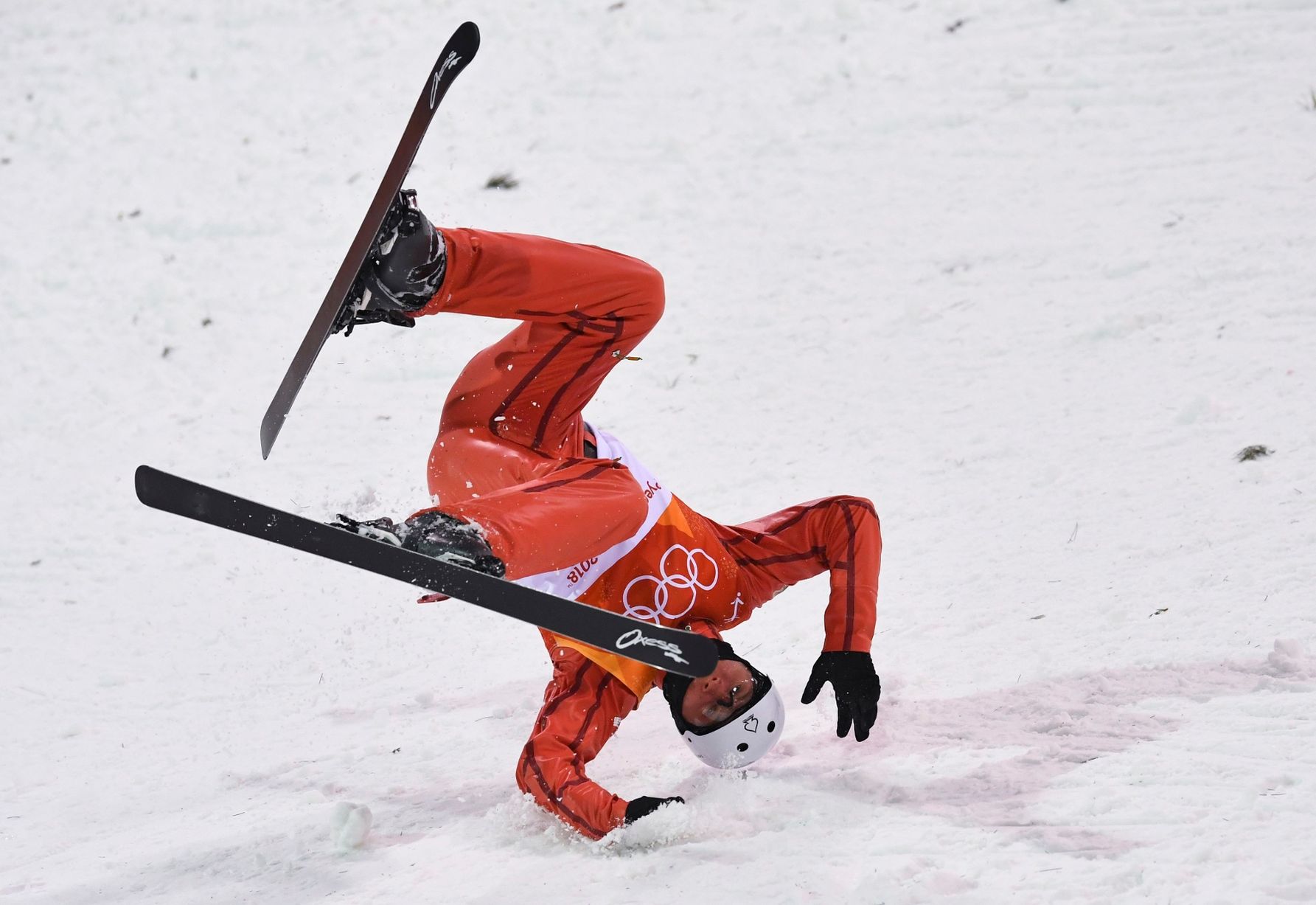 A skiier taking a tumble at the Olypmics